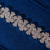 8.5MM iced out cross link bracelet in white gold with sparkling CZ stones on blue background