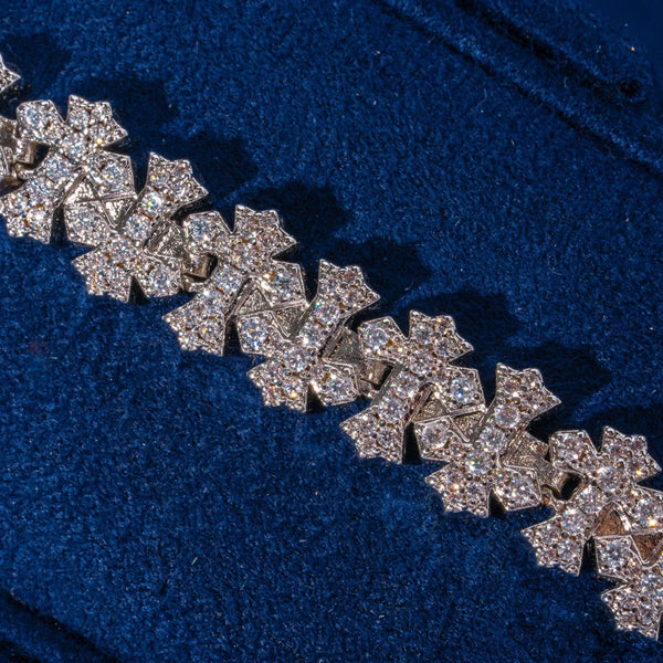 8.5MM iced out cross link bracelet in white gold with sparkling CZ stones on blue background