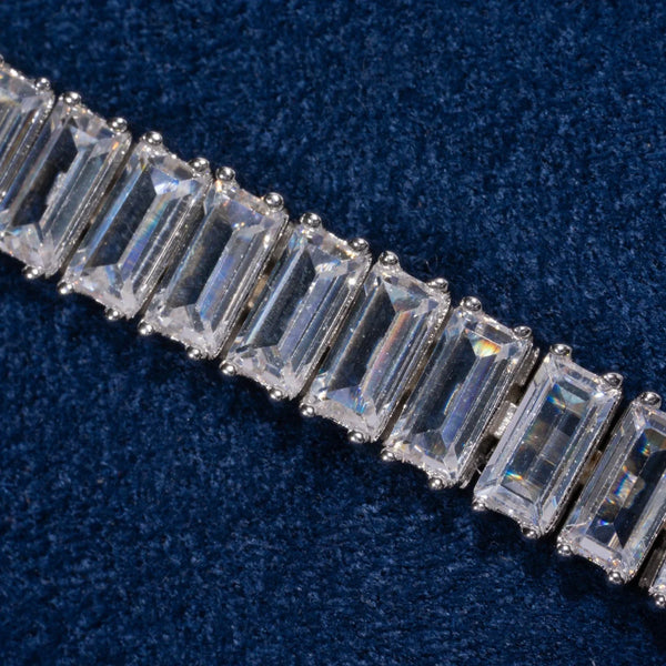 Close-up of 8MM Moissanite Baguette Tennis Bracelet with 925 silver setting on dark blue fabric background