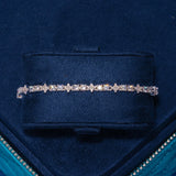 3MM Moissanite Round and Star iced tennis bracelet in 925 silver with D color VVS1 stones on navy blue velvet display