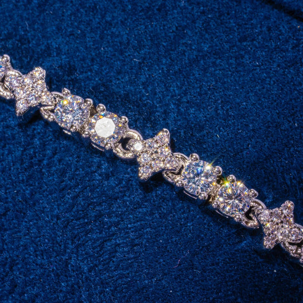 3MM Moissanite Round and Star iced tennis bracelet in 925 silver with D color VVS1 stones on blue fabric background