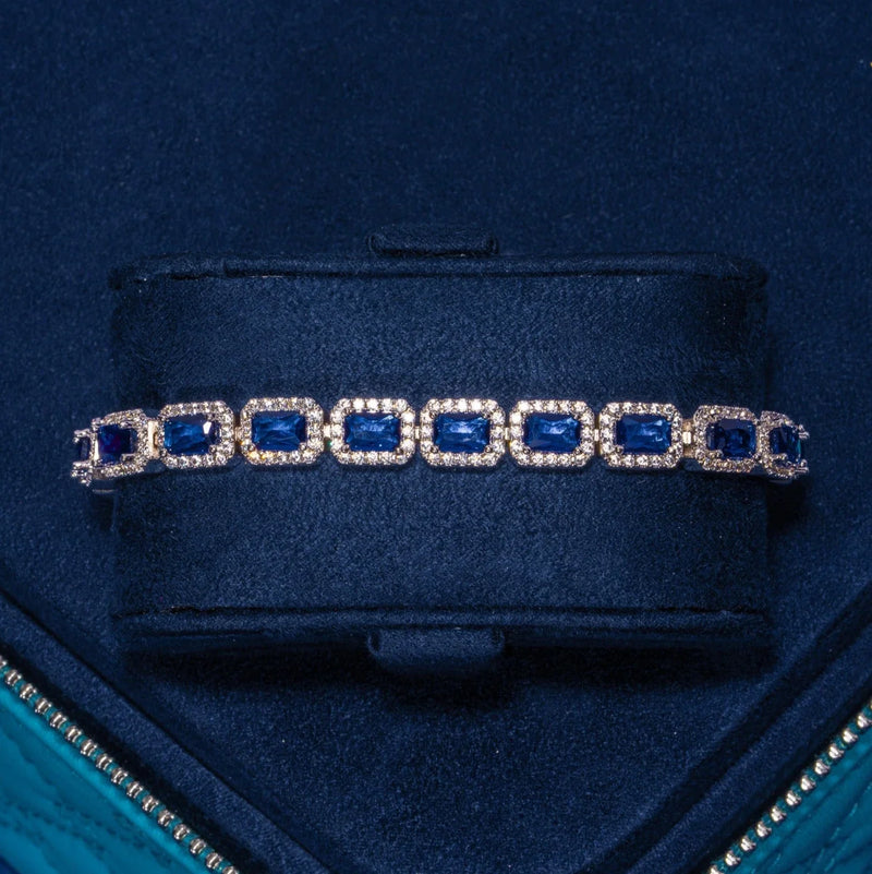 18K white gold sapphire cushion cut tennis bracelet with sparkling cubic zirconia accents in navy blue velvet box