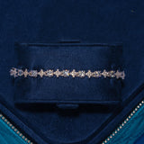 Round Stone Star Tennis Bracelet in white gold with round stones set in star motifs displayed in a blue velvet box