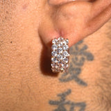 Close-up of moissanite 3-row hoop earrings with sparkling stones on ear