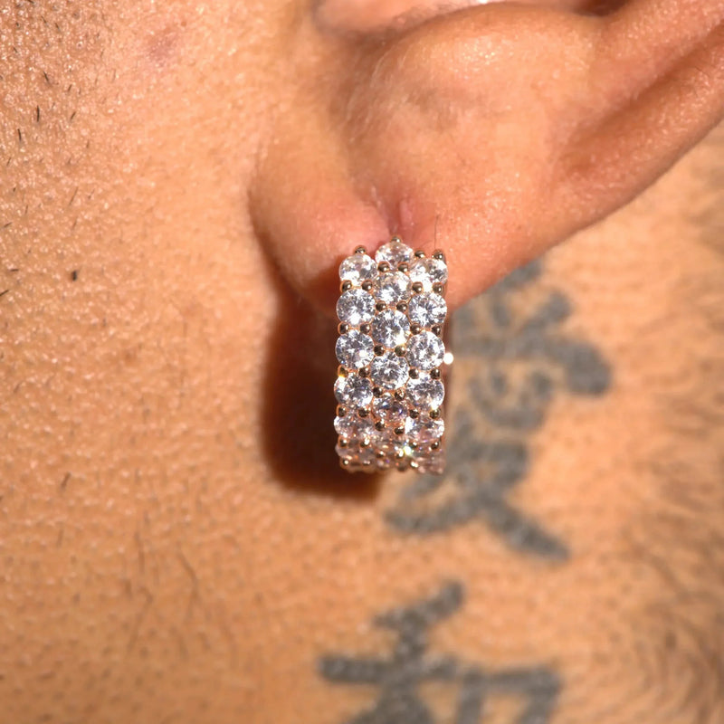 Close-up of moissanite 3-row hoop earrings with sparkling stones on ear