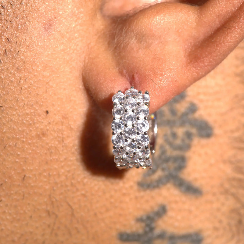 Close-up of a moissanite 3-row hoop earring in 925 silver worn on ear with sparkling stones