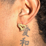 Gold Moissanite S925 heart-shaped earring worn on ear with adjacent tattoo, handcrafted with VS diamond simulants