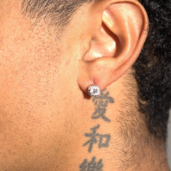 Moissanite 7mm cluster stud earring in 925 silver worn on ear with tattoo background