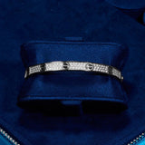 White gold Iced Band Bracelet with flawless VS diamond simulants on navy blue cushion