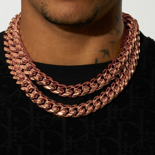 Close-up of a person wearing a rose gold 20mm Cuban iced clasp chain featuring moissanite stones and 925 silver, styled for a bold look