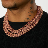 Moissanite 20mm rose gold Cuban iced clasp chain on neck in black shirt