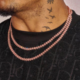 Rose gold moissanite broken heart chain on neck with black shirt and tattoo background