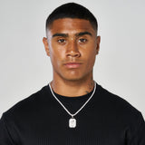 man wearing white gold palm tree pendant necklace with black shirt