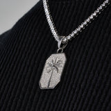 White gold palm tree pendant necklace with diamond simulants on black fabric
