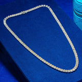 6MM Baguette Tennis Chain in white gold on blue background.