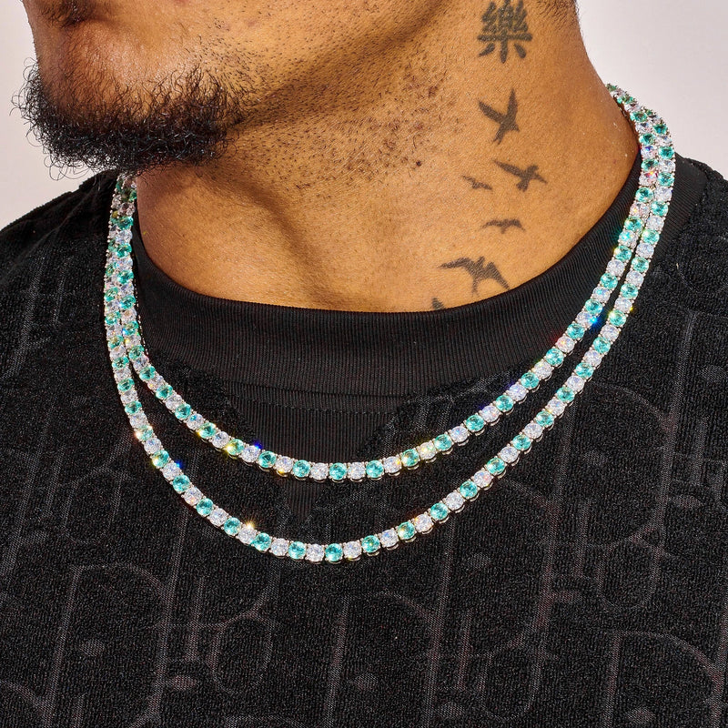 5MM Blue and White Tennis Chain in white gold worn on neck with green and white stones