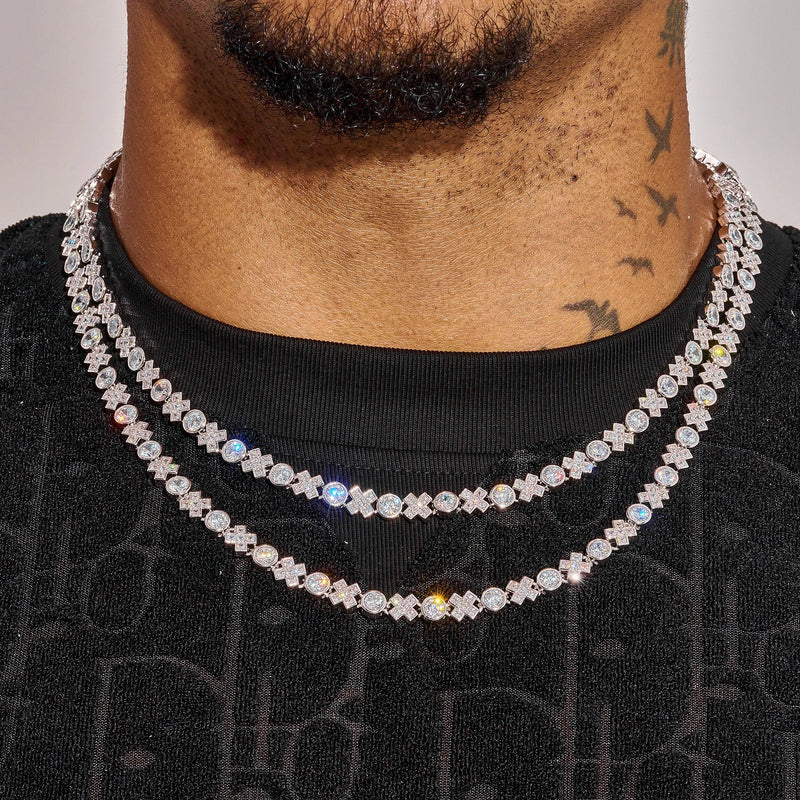 Close-up of a man wearing two white gold 5MM XOXO chains with diamond simulants and a black shirt.
