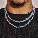 5MM Moissanite Blue Motif Tennis Chain necklace in white gold plating with VVS1 D color stones on a model's neck