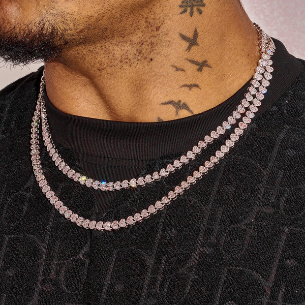 Men's white gold broken heart chain necklace with diamond simulants, layered style close-up