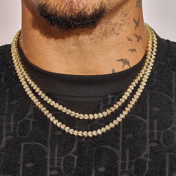 Gold Broken Heart Chain necklace on man with tattoos, layered fashion accessory