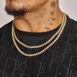 Broken Heart Chain gold plated necklace with diamonds worn layered on male model's neck