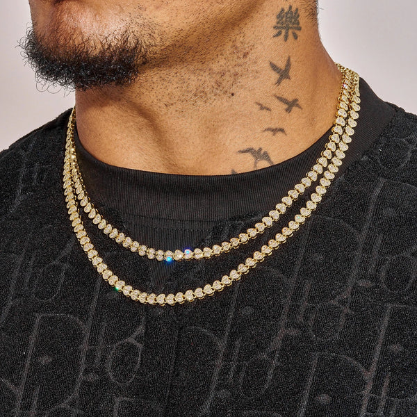 Broken Heart Chain gold plated necklace with diamonds worn layered on male model's neck