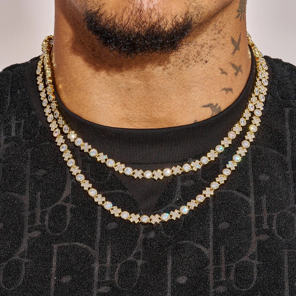 Close-up of a man wearing two gold 5MM XOXO Chains with diamond simulants on a black shirt