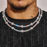 Close-up of 5MM Moissanite Iced Motif tennis chain in white gold plating on men's neck