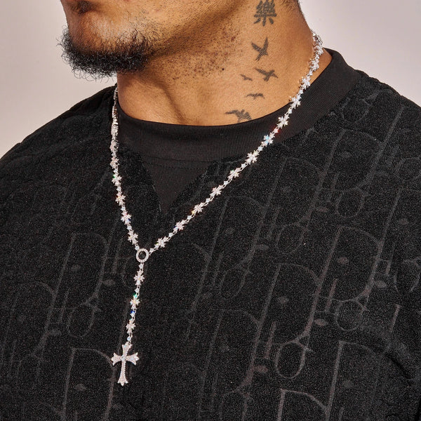 Flared Cross Rosary tennis chain in white gold with radiant stones worn by man