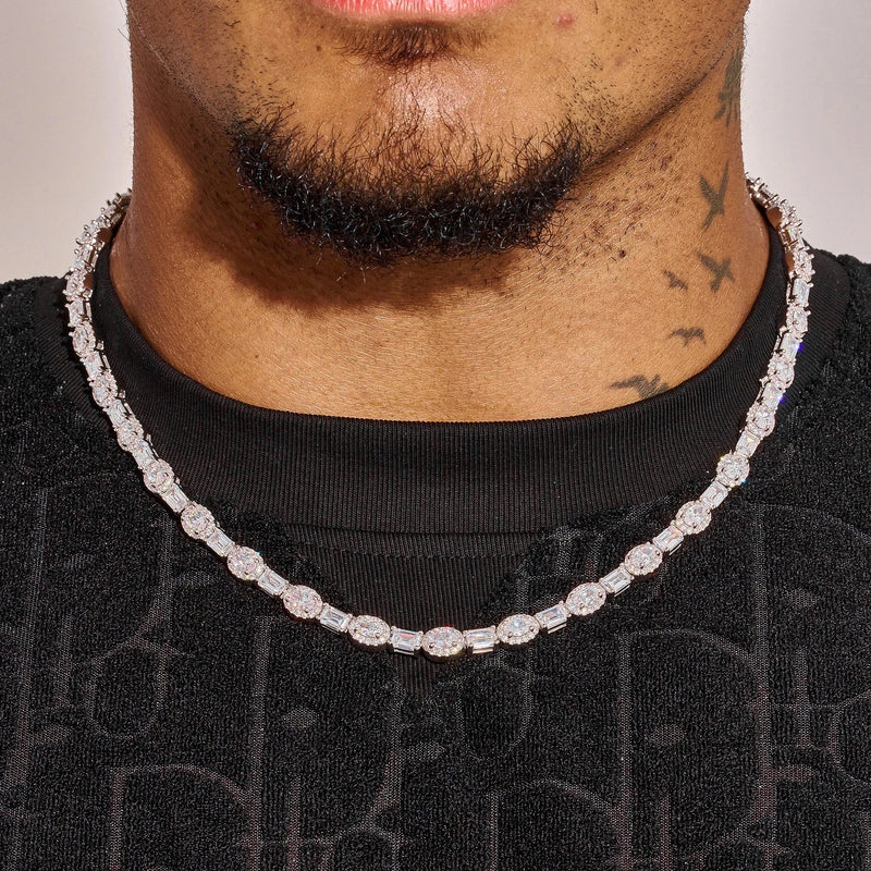 Close-up of 7MM moissanite oval emerald cut tennis chain in 925 silver with white gold plating worn on neck