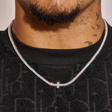 3MM Tennis Cross Chain in white gold with diamond simulants on a man wearing black shirt
