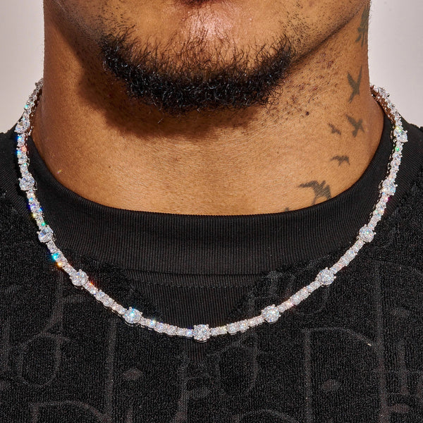 Close-up of Gem Stationed Tennis Chain in white gold with spaced gemstones worn on neck