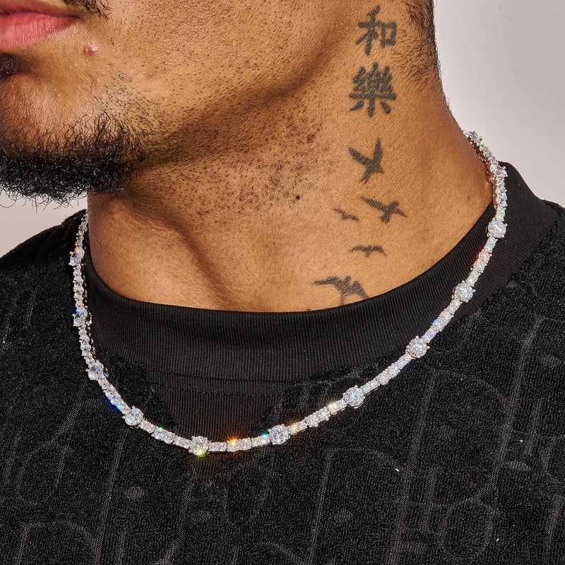 Gem Stationed Tennis Chain in white gold with spaced gemstones worn around neck