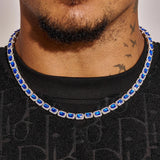 Close-up of Sapphire Cushion Cut Tennis Chain in white gold worn on neck with deep blue cushion-cut sapphires and diamond simulants