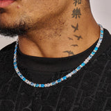 5MM Blue Ovals Tennis Chain in white gold with vibrant blue oval stones and diamond simulants worn on neck