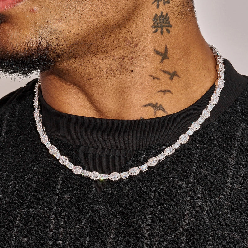 7MM Oval Emerald Cut Tennis Chain in white gold worn on neck with oval emerald cut stones and diamond simulants