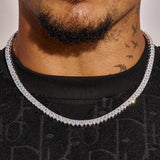 Close-up of a man wearing a 6MM pear cut tennis chain in white gold with sparkling stones