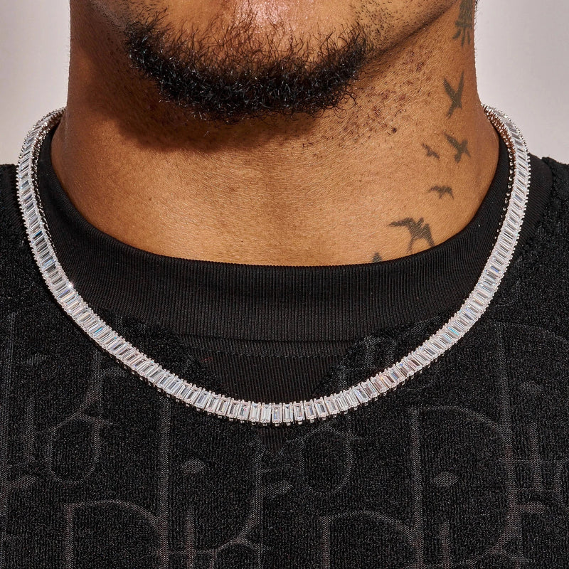Close-up of 6MM Moissanite Baguette tennis chain necklace in 925 silver worn on a man's neck