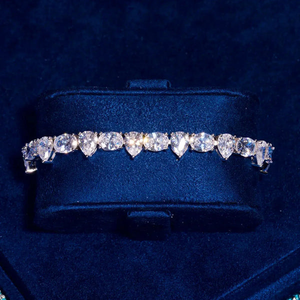 8MM opal and pear tennis bracelet in white gold with radiant stones on dark blue background