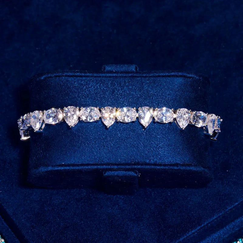 8MM opal and pear tennis bracelet in white gold with radiant stones on dark blue background