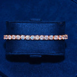5mm Moissanite tennis bracelet in rose gold with round cut stones on blue velvet display