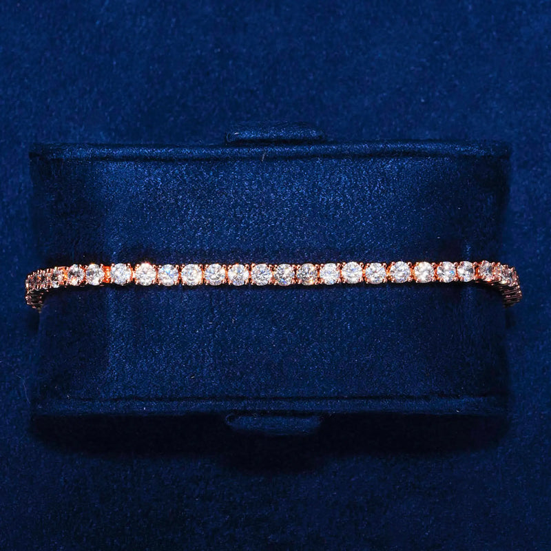 3mm Moissanite tennis bracelet in rose gold with round cut stones on 925 silver displayed on navy blue cushion