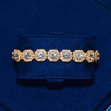 10mm Clustered Tennis Bracelet Gold with hand-set stones and 18K plating on dark blue background