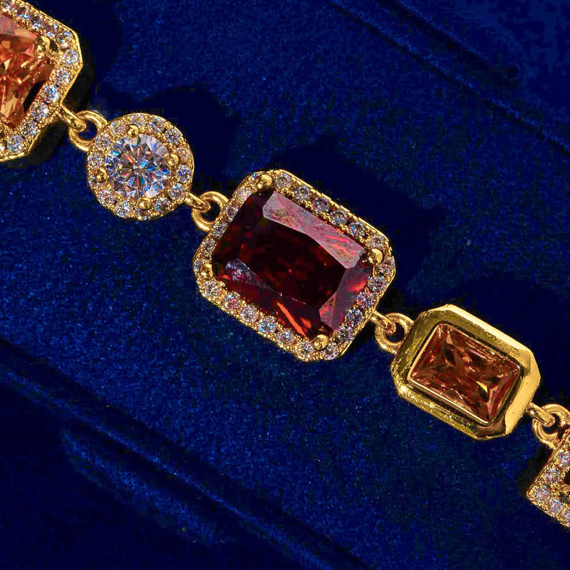 10MM Multi Gemstone Bracelet - Gold with large center stones and CZ accents on blue background