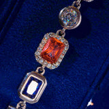 Close-up of 10MM multi gemstone bracelet in white gold featuring hand-set prong-lifted stones with diamond simulants on dark blue background