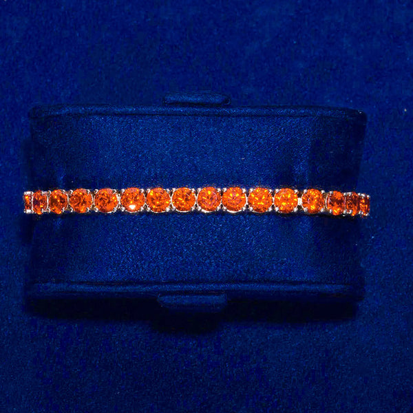 5mm red ruby tennis bracelet with 18K gold plating and flawless VS diamond simulants on blue display cushion