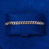 6mm white gold Cuban link bracelet on a navy blue cushion display
