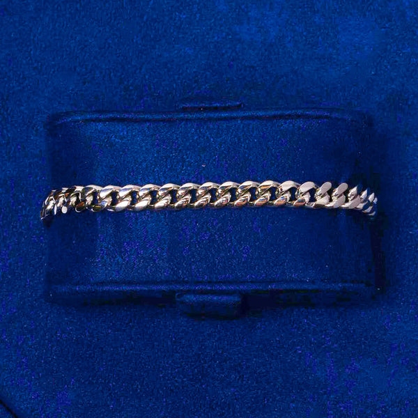 6mm white gold Cuban link bracelet on a navy blue cushion display
