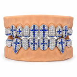 Silver moissanite grillz set with blue cross motifs across upper and lower teeth, front view