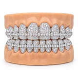 Fully iced silver moissanite grillz with a tennis bar running across both the upper and lower sets, front view